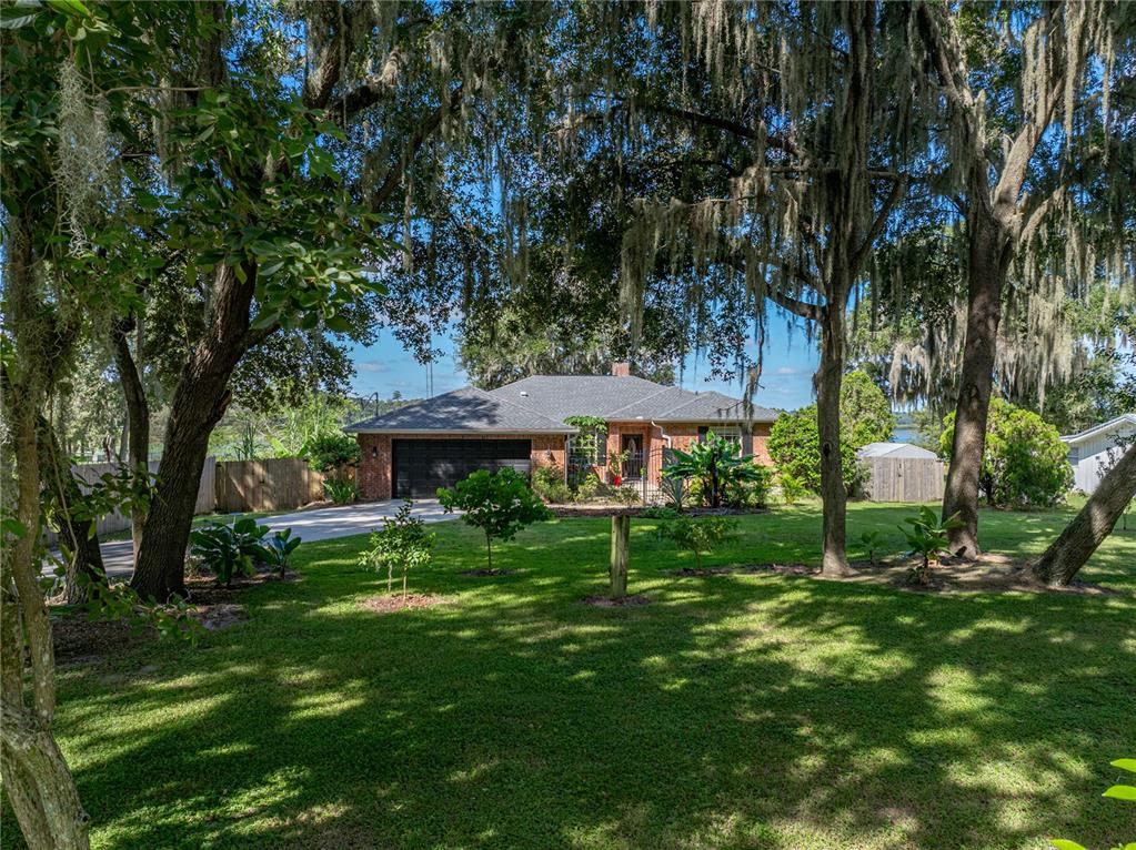 18331 Townsend House Road Dade City, FL 33523 - Photo 1 of 1 a view of a table and chairs under an umbrella