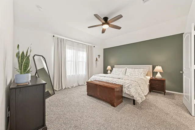 a bedroom with a bed and a window