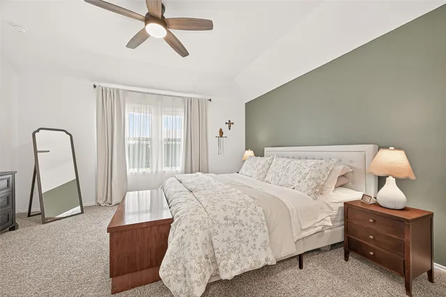 a bedroom with a bed window and potted plant