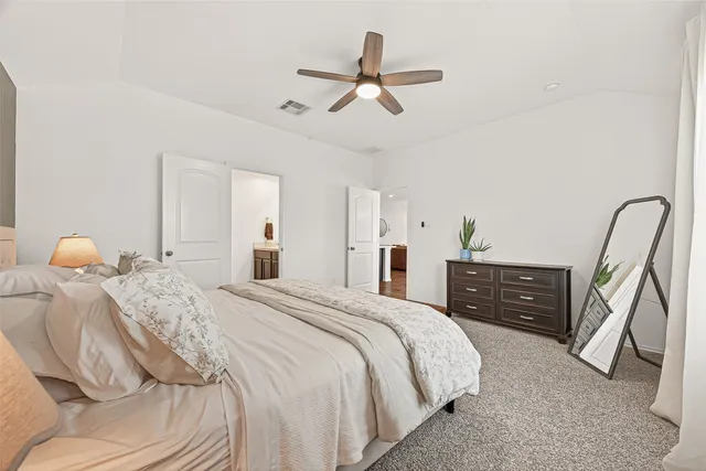 a bedroom with a bed and cabinets