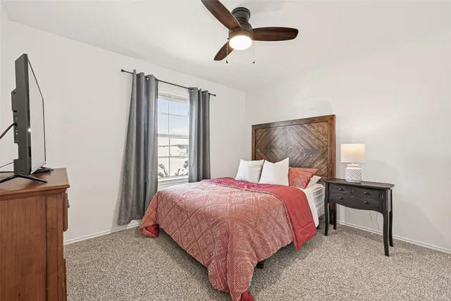 a bedroom with a bed dresser and a window