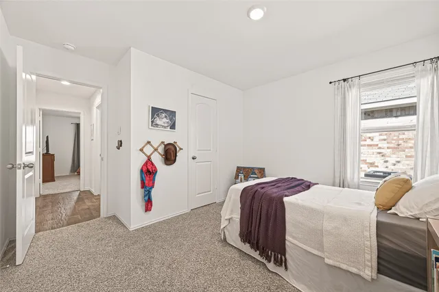 a bedroom with a bed and a painting