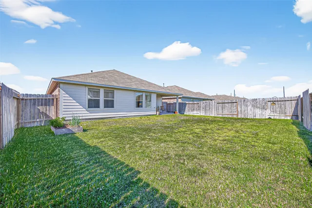 a view of a house with a backyard and a table