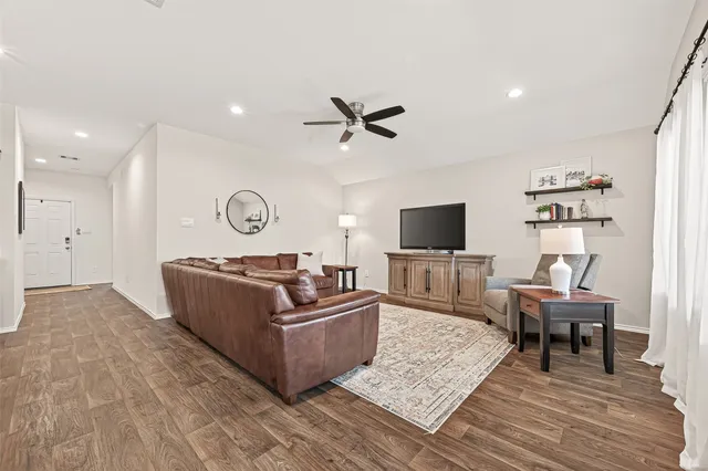 a living room with furniture and kitchen view