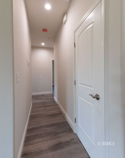 327 Abigail Street Ridgecrest, CA 93555 - Photo 14 of 35 a view of a hallway with wooden floor and staircase