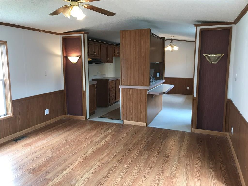 230 Poplar Street Rochester, PA 15074 - Photo 5 of 15 Living room looking into kitchen. Newer laminate flooring.