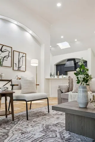 a living room with furniture and a potted plant