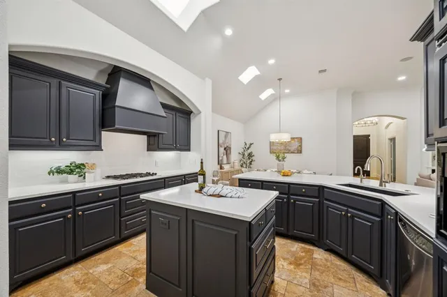 a kitchen with a sink a stove and cabinets