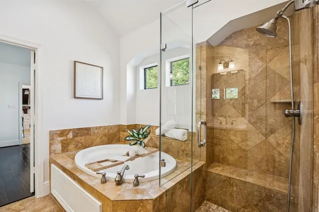 a bathroom with a tub and a shower