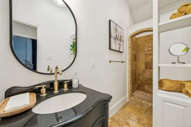a bathroom with a sink mirror and a toilet