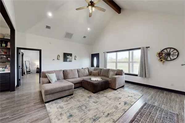 a kitchen with a dining table chairs stainless steel appliances and cabinets