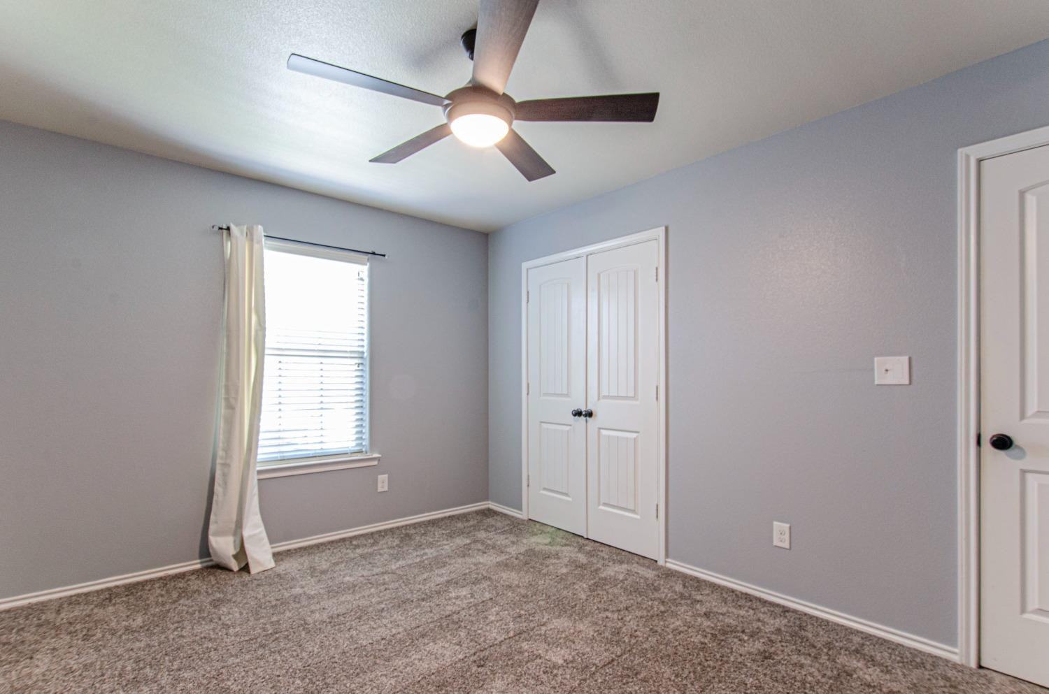 9105 Rochester Avenue Lubbock, TX 79424 - Photo 12 of 24 a view of an empty room with a window
