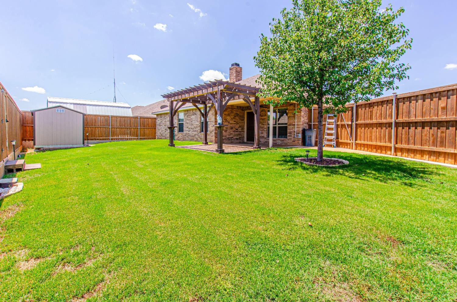 9105 Rochester Avenue Lubbock, TX 79424 - Photo 17 of 24 a view of a house with a yard and a patio