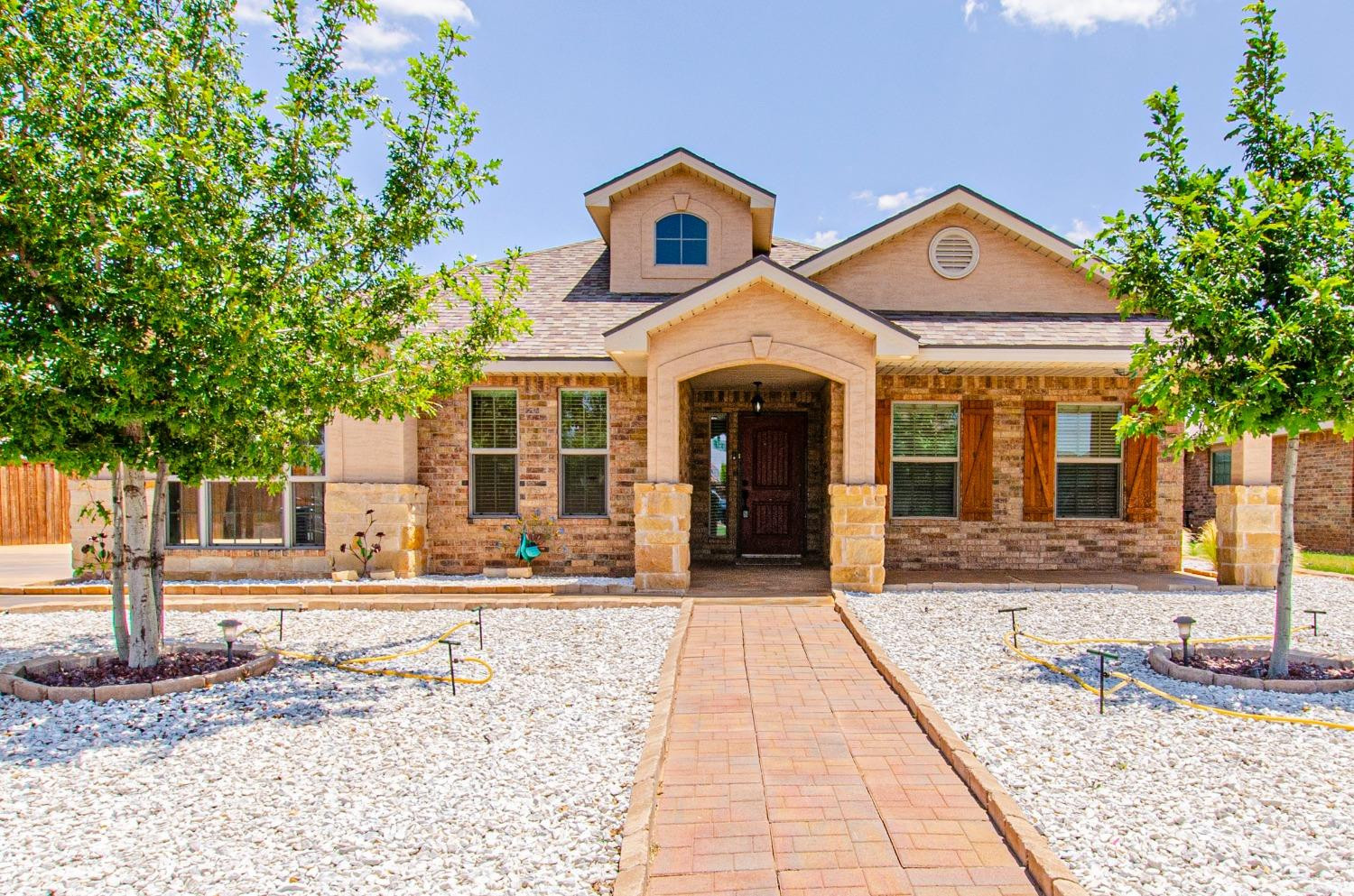 9105 Rochester Avenue Lubbock, TX 79424 - Photo 19 of 24 a front view of a house with garden