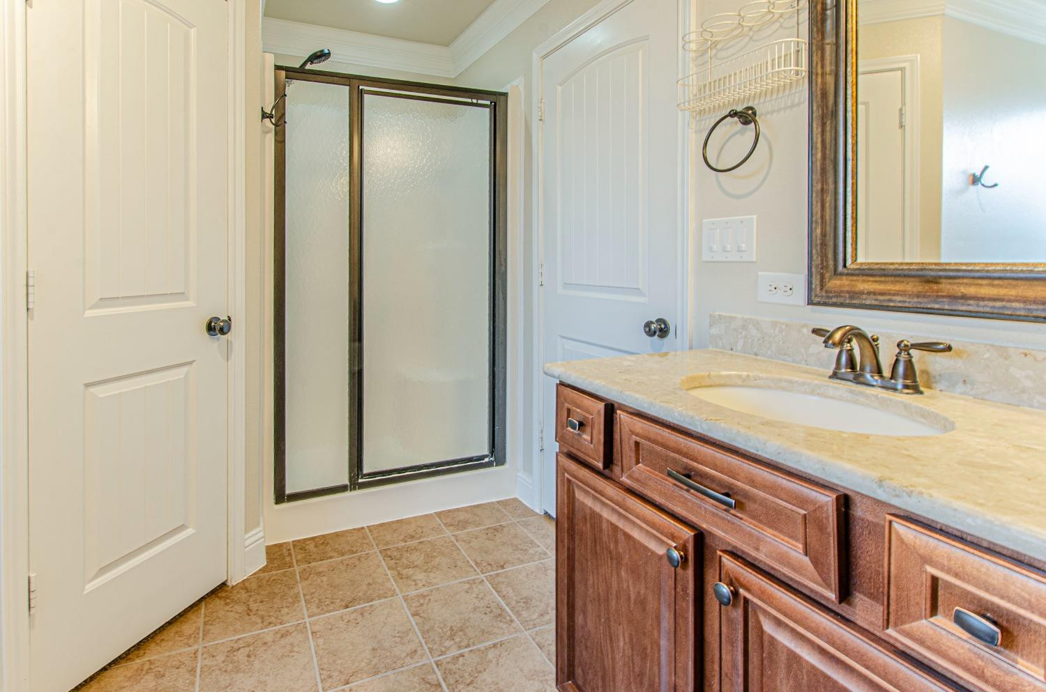 9105 Rochester Avenue Lubbock, TX 79424 - Photo 3 of 24 a bathroom with a sink and a mirror