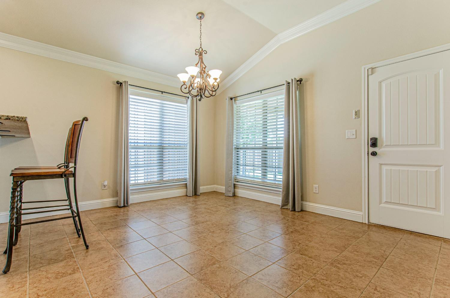 9105 Rochester Avenue Lubbock, TX 79424 - Photo 4 of 24 a view of a livingroom with a chandelier and furniture