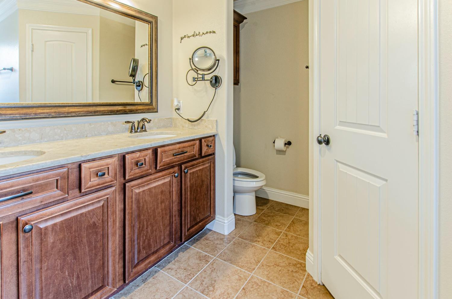 9105 Rochester Avenue Lubbock, TX 79424 - Photo 6 of 24 a bathroom with a granite countertop sink and a mirror