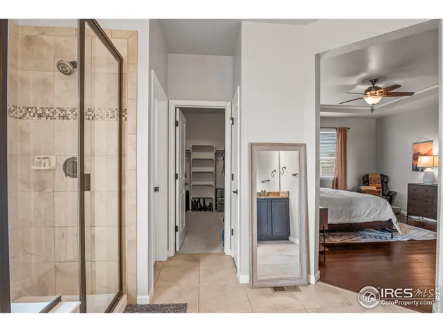 a living room with a bed and a walk in closet
