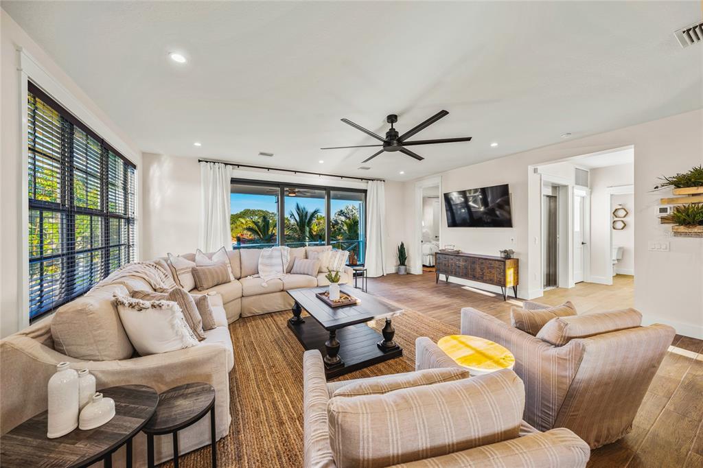 6910 Midnight Pass Road, Unit A Sarasota, FL 34242 - Photo 11 of 40 a living room with furniture and a large window