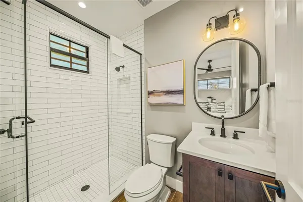 a bathroom with a sink toilet and shower