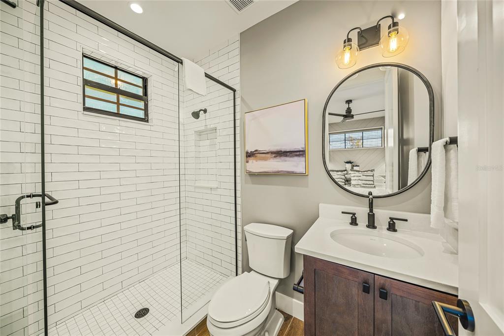 6910 Midnight Pass Road, Unit A Sarasota, FL 34242 - Photo 18 of 40 a bathroom with a sink toilet and shower