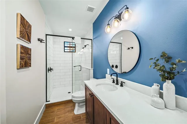 a bathroom with a sink a toilet and a mirror