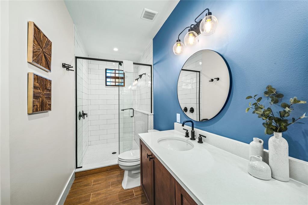 6910 Midnight Pass Road, Unit A Sarasota, FL 34242 - Photo 21 of 40 a bathroom with a sink a toilet and a mirror