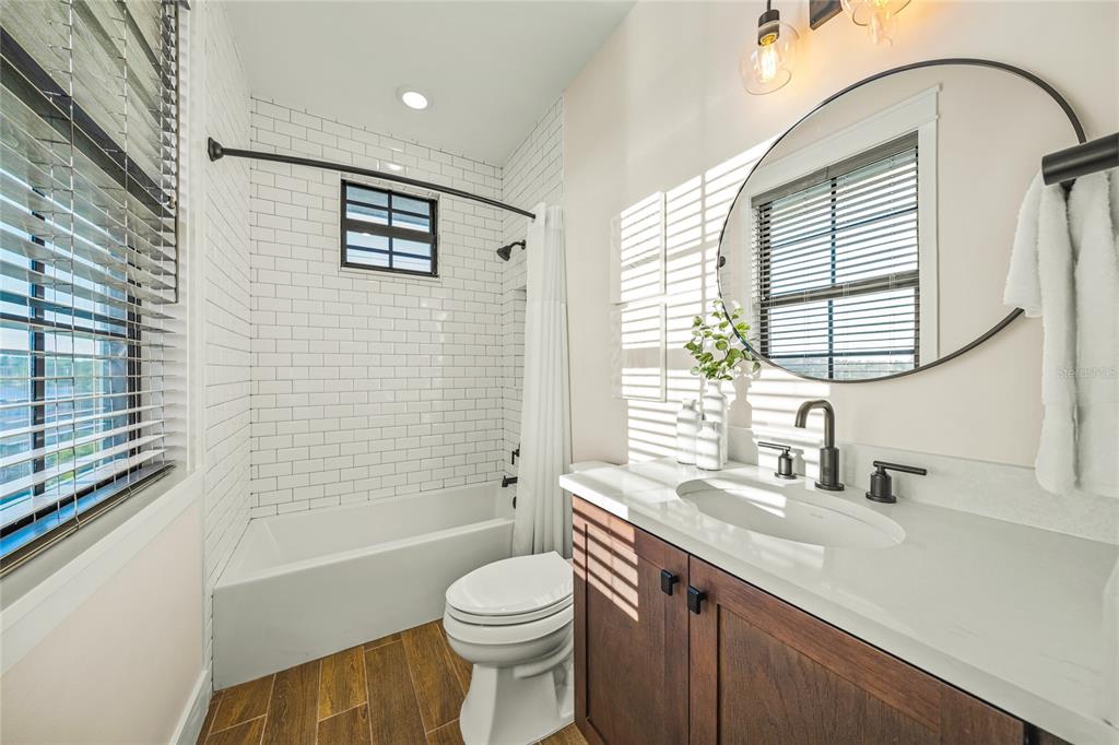 6910 Midnight Pass Road, Unit A Sarasota, FL 34242 - Photo 23 of 40 a bathroom with a sink a toilet and tub