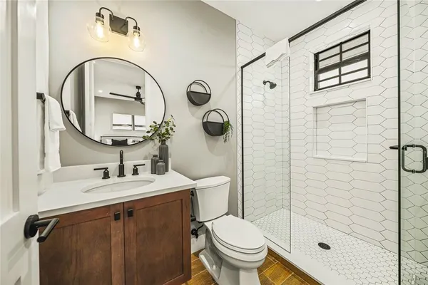 a bathroom with a sink toilet and shower