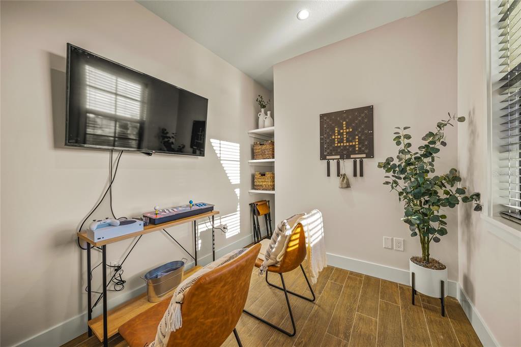 6910 Midnight Pass Road, Unit A Sarasota, FL 34242 - Photo 27 of 40 a living room with furniture and a flat screen tv