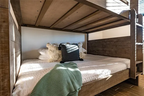 a bed sitting in a bedroom next to a balcony