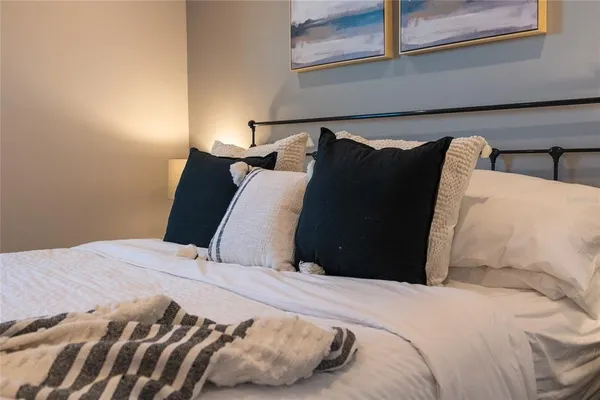 a bedroom with bed and a window