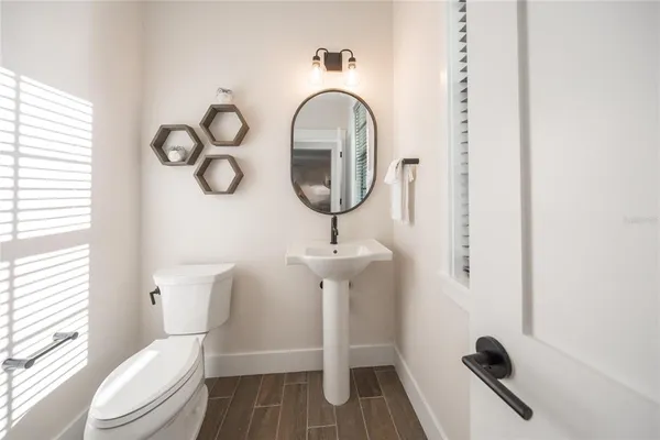a bathroom with a toilet a sink and a window
