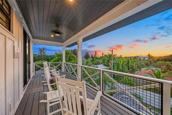 a view of a chairs and table in balcony