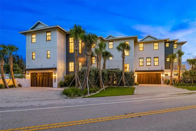 a view of a brick house with a yard next to a road
