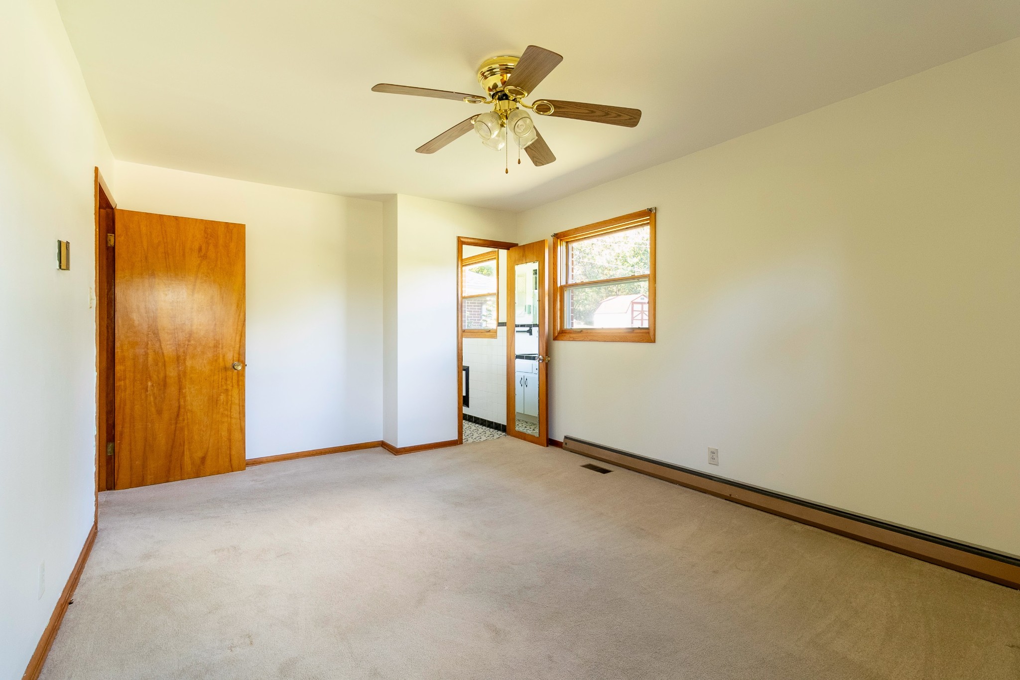 3241 West Main Street Erin, TN 37061 - Photo 12 of 22 an empty room with windows and fan