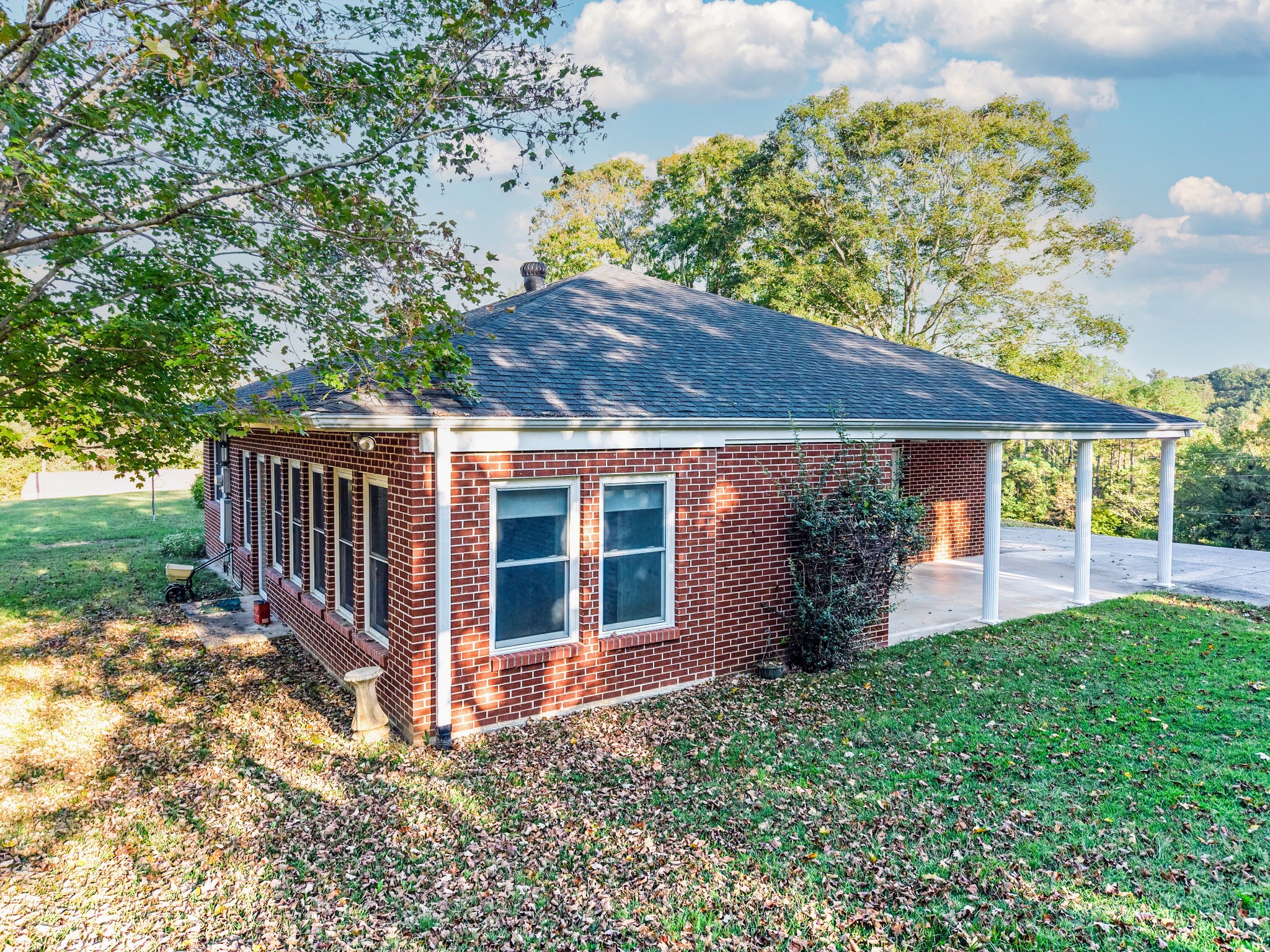 3241 West Main Street Erin, TN 37061 - Photo 20 of 22 a view of a house with backyard and porch