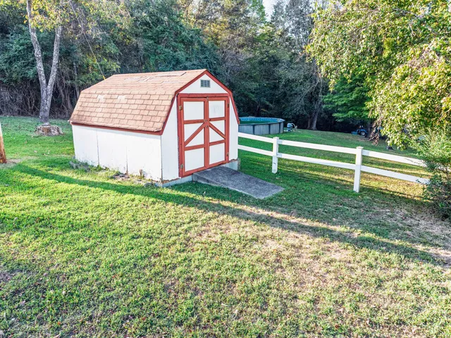 a view of a house with a yard and sitting area
