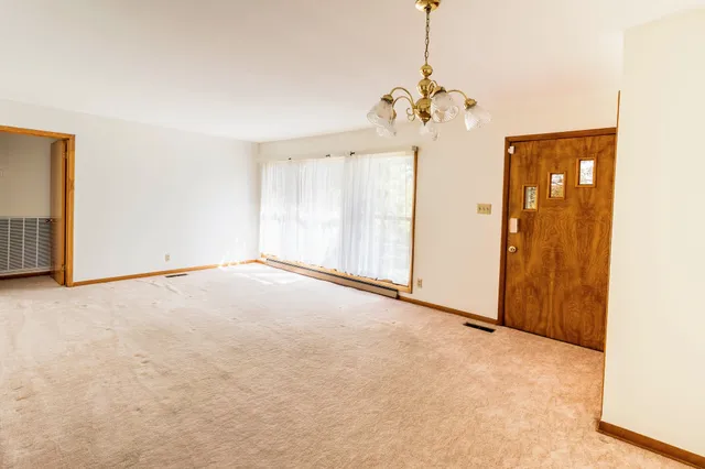 a view of a chandelier fan and refrigerator in a room