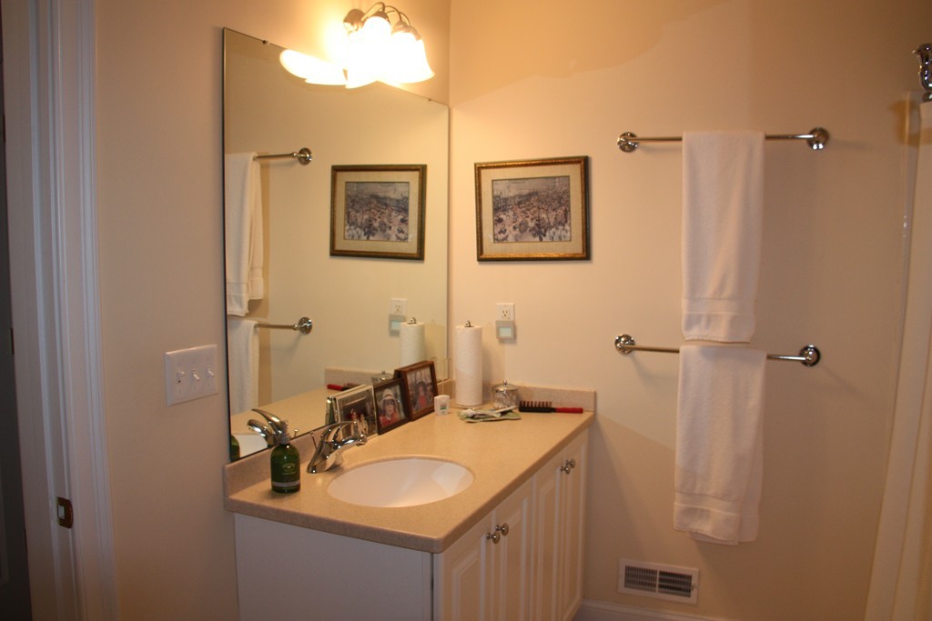 3 Ellsworth Village Road, Unit 2 Acton, MA 01720 - Photo 13 of 25 a bathroom with a sink and a mirror