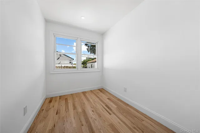 a view of room with window and wooden floor