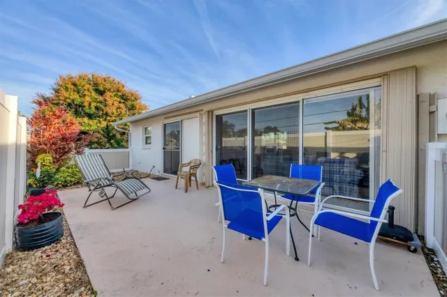 a building outdoor space with patio furniture and potted plants