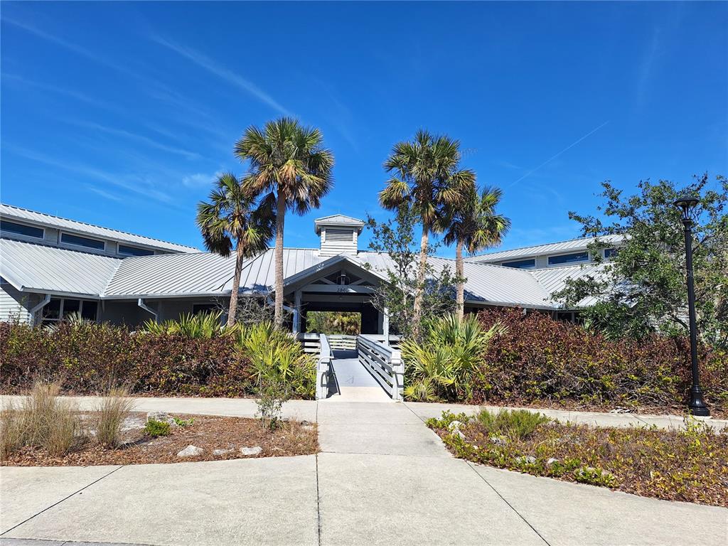 571 Morningside Road Venice, FL 34293 - Photo 26 of 36 a front view of a house with a yard and a fountain