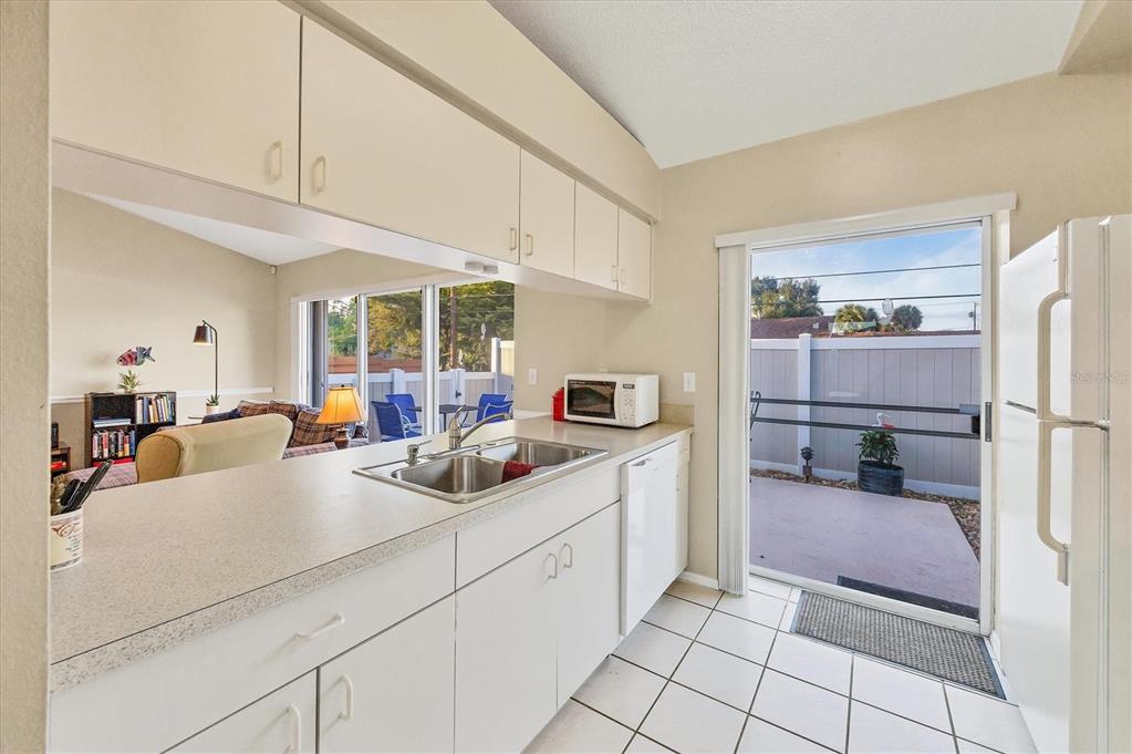 571 Morningside Road Venice, FL 34293 - Photo 9 of 36 a kitchen with kitchen island a sink a counter and appliances