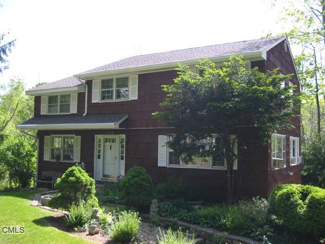 62 Riverside Drive Ridgefield, CT 06877 - Photo 1 of 1 front view of a house with a yard