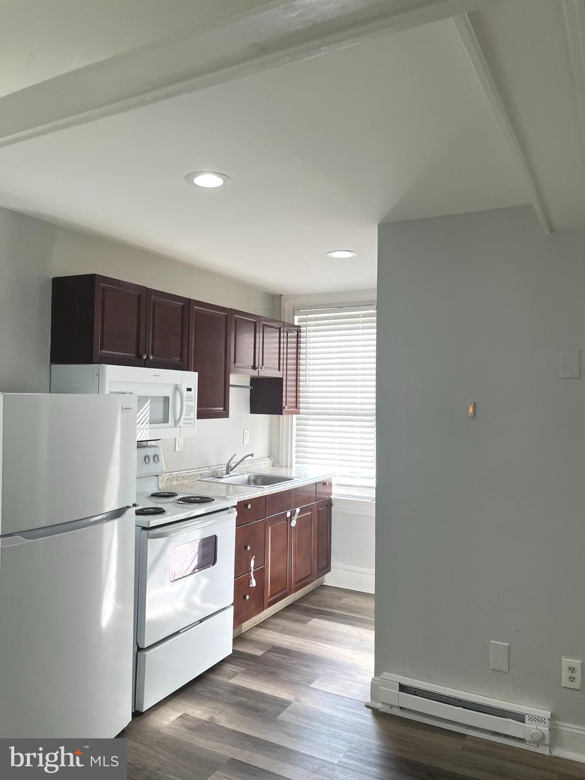 a kitchen with stainless steel appliances a refrigerator and a stove top oven