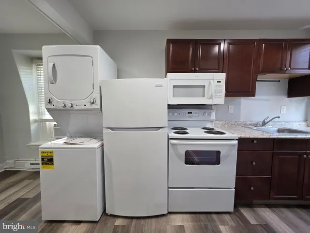 a kitchen with a stove a sink and a refrigerator