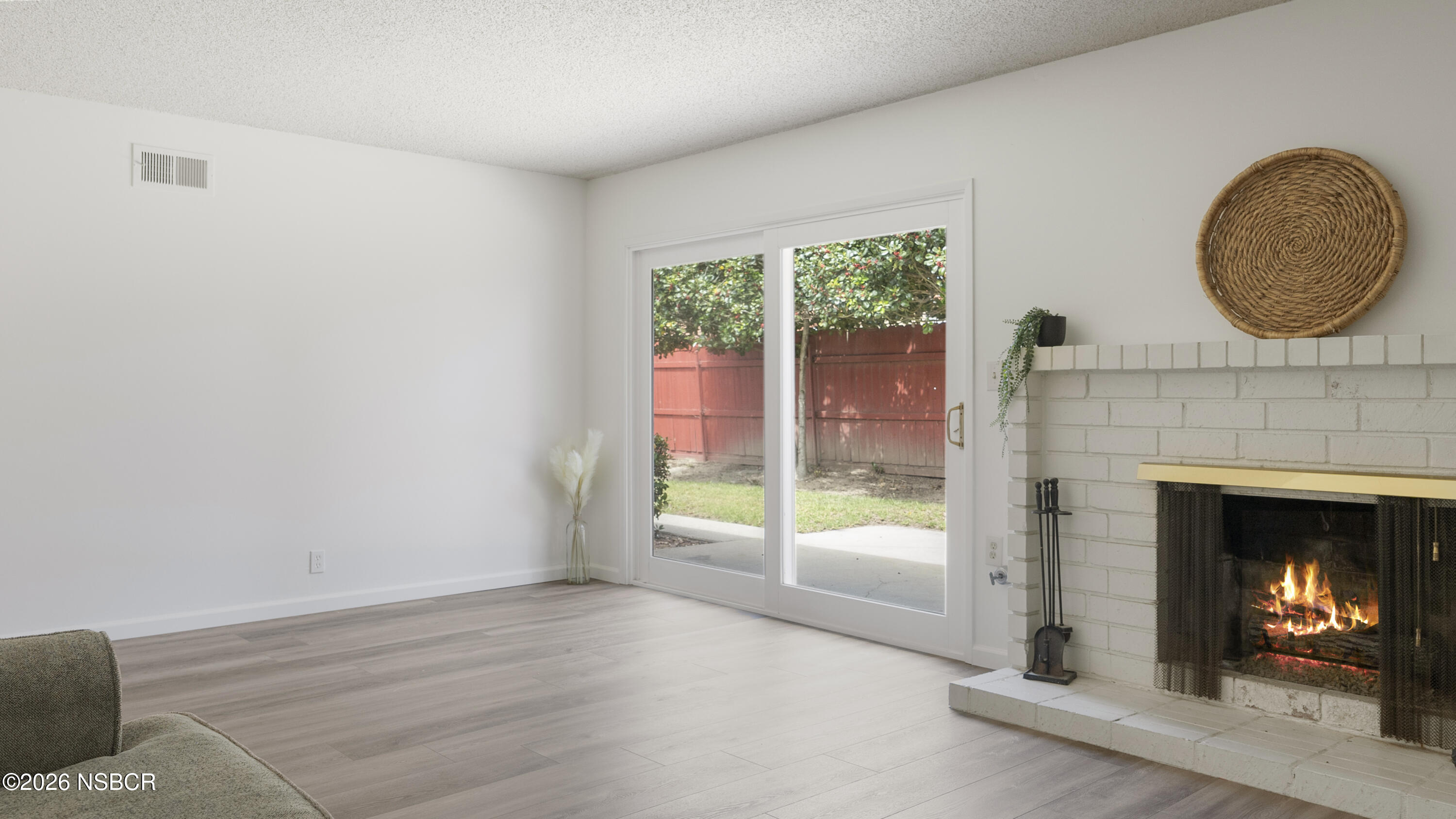1312 North First Place Lompoc, CA 93436 - Photo 13 of 38 a view of an empty room with a fireplace and window