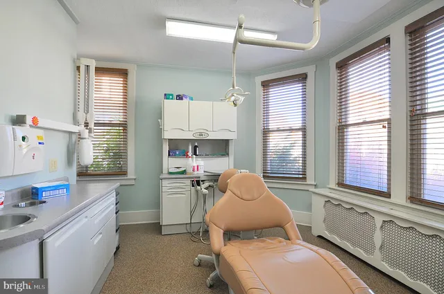 a living room with furniture a window and gym equipment