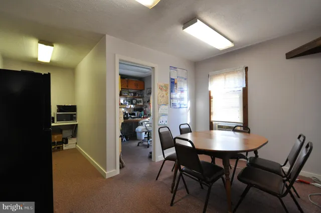 a view of a dining room with furniture and a chandelier